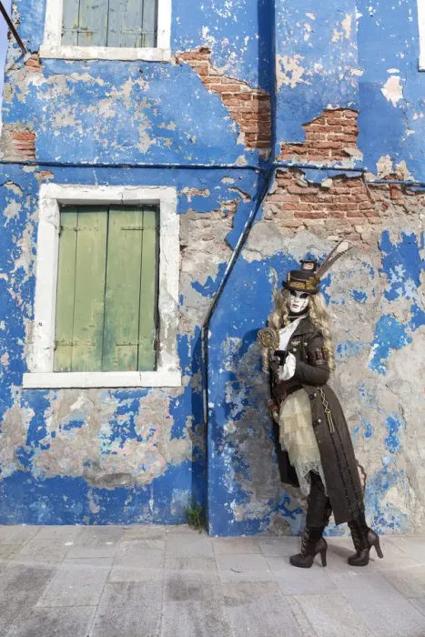 Framed Print : Woman in steampunk costume posing in front of old blue house, Burano Island, Venice Framed Print : Woman in steampunk costume posing in front of old blue house, Burano Island, Venice
