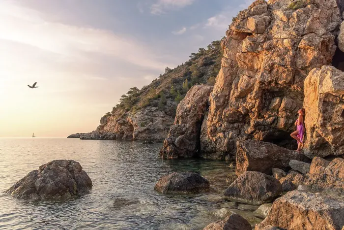 Framed Print : Woman in sunset light on the rocks, Ibiza, Spain Framed Print : Woman in sunset light on the rocks, Ibiza, Spain