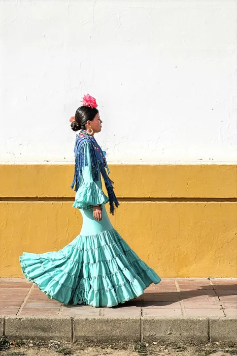 Framed Print : Woman traditionally dressed walking in a street during the El Rocio pilgrimage, El Rocio, Huelva, Andalusia, Spain
