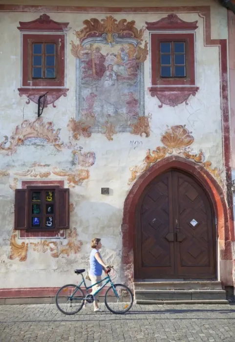 Framed Print : Woman walking past decorative building in Radnicne Square, Bardejov (UNESCO World Heritage Site)