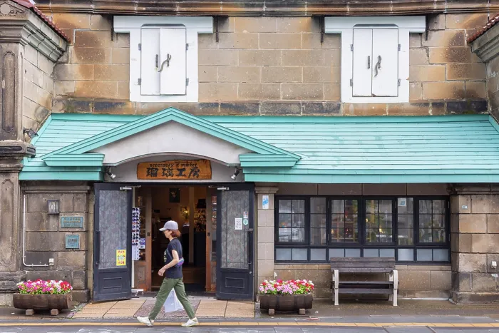 Framed Print : Woman walking past old stone store, Otaru, Hokkaido, Japan Framed Print : Woman walking past old stone store, Otaru, Hokkaido, Japan