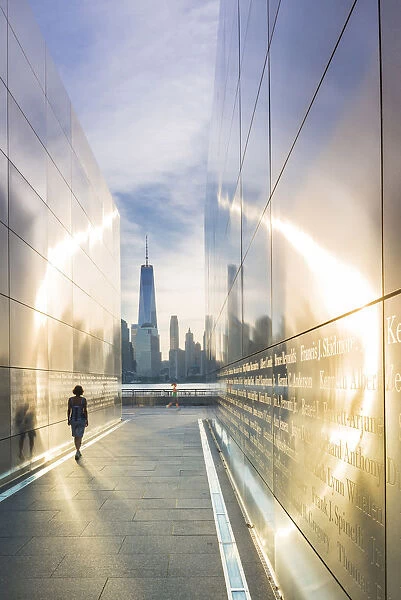 Woman walking through the Empty skies 9  /  11 memorial in Liberty state park, New York, USA