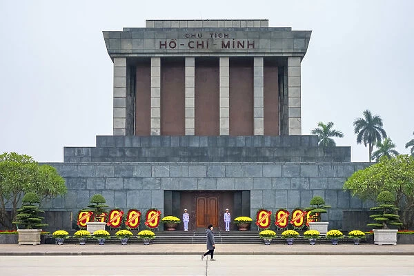A woman walks past Ho Chi Minh Mausoleum on Ba Dinh Square, Hanoi, Vietnam