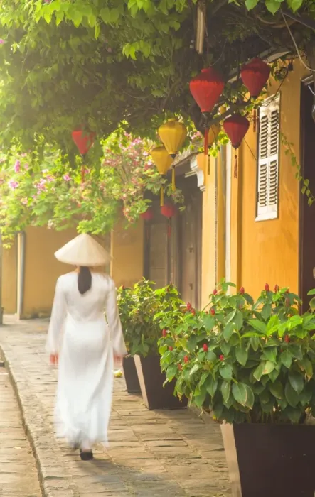 Framed Print : Woman wearing Ao Dai dress walking along street, Hoi An (UNESCO World Heritage Site) Framed Print : Woman wearing Ao Dai dress walking along street, Hoi An (UNESCO World Heritage Site)