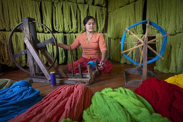 Woman winding up thread at weaving workshop on Lake Inle, Nyaungshwe Township