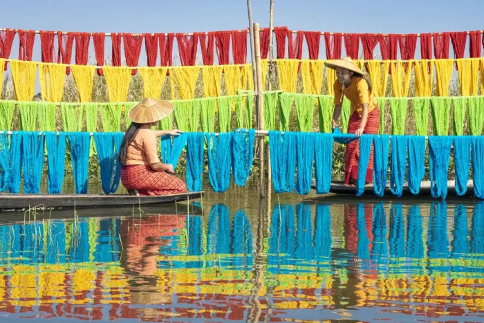 Framed Print : Two women hanging dyed yarn from boats to dry in a traditional weaving village on Lake Framed Print : Two women hanging dyed yarn from boats to dry in a traditional weaving village on Lake