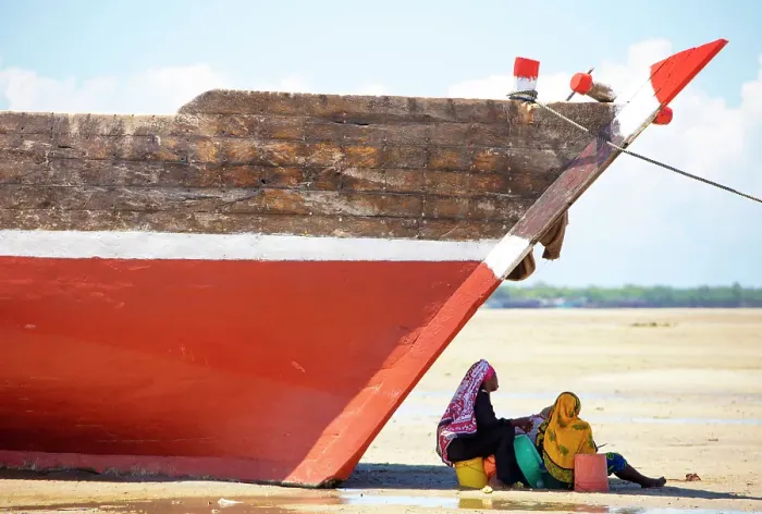 Framed Print : Two women sitting in the shade of a fishing boat on the beach, Mkokotoni, Zanzibar, Tanzania Framed Print : Two women sitting in the shade of a fishing boat on the beach, Mkokotoni, Zanzibar, Tanzania