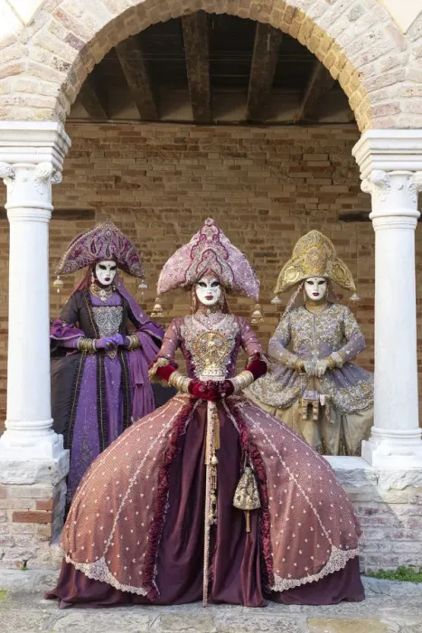 Framed Print : Three women wearing Indian style costumes and masks pose in the cloisters of Chiesa di Framed Print : Three women wearing Indian style costumes and masks pose in the cloisters of Chiesa di