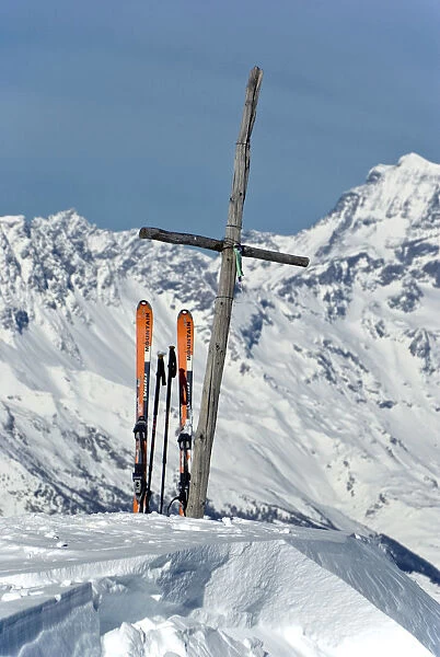 The wood cross on top of Pointe de la Pierre, flanked by a pair of mountaineering