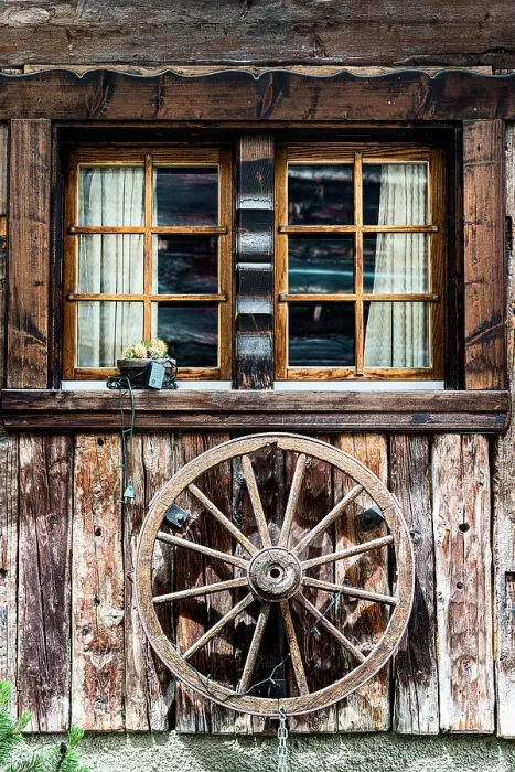 Framed Print : Wood facade of a mountain chalet decorated with an old wheel, Zermatt, canton of Valais, Switzerland Framed Print : Wood facade of a mountain chalet decorated with an old wheel, Zermatt, canton of Valais, Switzerland