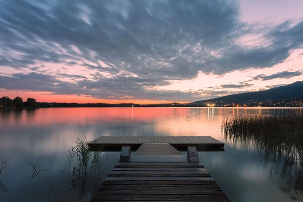 Wood pier on Pusiano lake at sunset, Bosisio Parini, Lecco province, Lombardy, italy