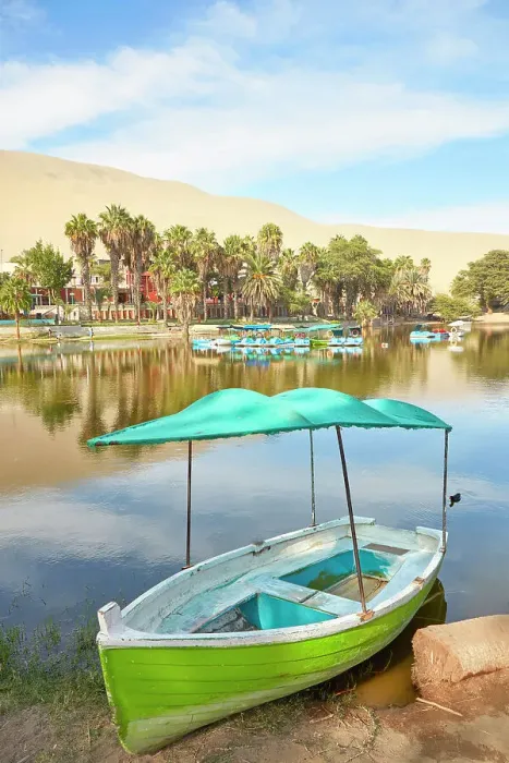 Framed Print : A wooden boat on the shore of the Huacachina Oasis, Ica, Peru Framed Print : A wooden boat on the shore of the Huacachina Oasis, Ica, Peru