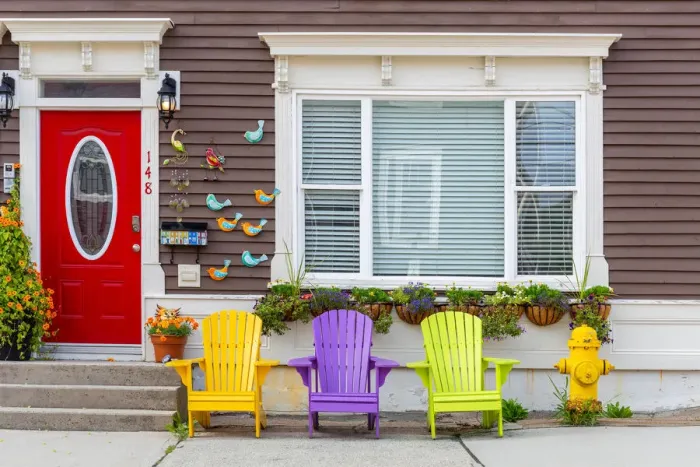 Framed Print : Wooden colorful dechchairs in front of traditional house in St Johns downtown Framed Print : Wooden colorful dechchairs in front of traditional house in St Johns downtown
