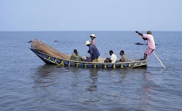A wooden fishing boat with fish traps in the bow leaves Rwenshama