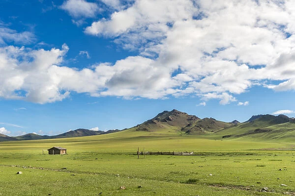 Wooden house and clouds in the sky. Hovsgol province, Mongolia