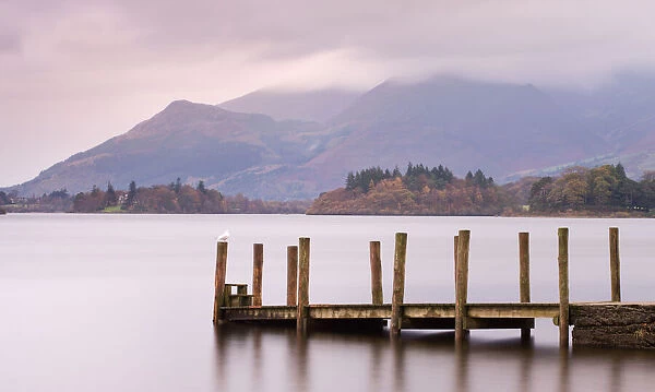 Wooden jetty on Derwent Water looking towards Skiddaw, Lake District National Park, Cumbria, England, UK. Autumn (November) 2009
