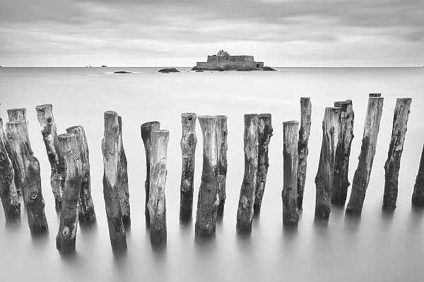 Wooden sea defence and Fort National at high tide, St