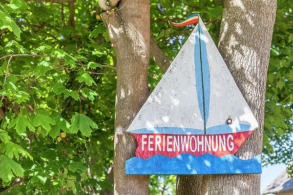 Wooden sign holiday apartment with motif sailing ship in Ahrenshoop, Mecklenburg-Western Pomerania, Baltic Sea, Northern Germany, Germany