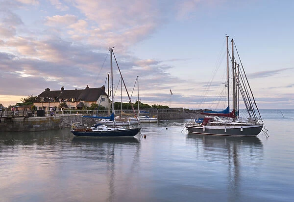 Yachts in Porlock Weir harbour at sunset, Exmoor, Somerset, England. Summer (July)