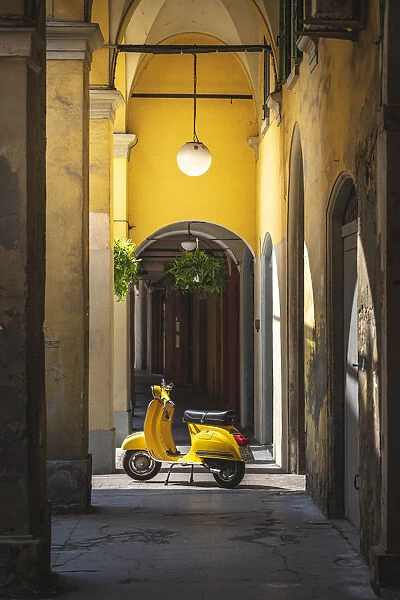 Yellow Vespa in Modena historic city. Modena old town, Emilia Romagna, Italy