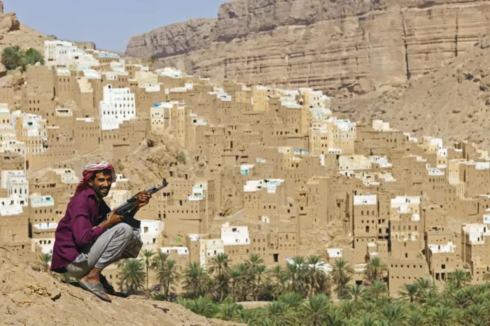 Framed Print : Yemen, Hadhramaut, Wadi Do an, Ribat Ba-Ashan. A happy Yemeni man holds his AK-47 Framed Print : Yemen, Hadhramaut, Wadi Do an, Ribat Ba-Ashan. A happy Yemeni man holds his AK-47
