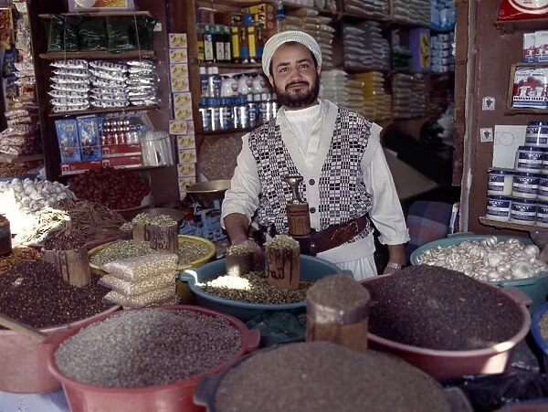 A Yemeni trader at his market stall in the old Suq