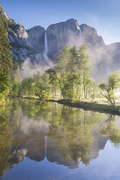 Yosemite Falls reflected in the Merced River at dawn, Yosemite National Park, California, USA