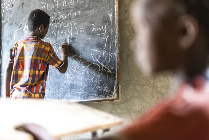 Framed Print : Young boy writing on blackboard at school, Melabday, Asso Bhole, Danakil Depression