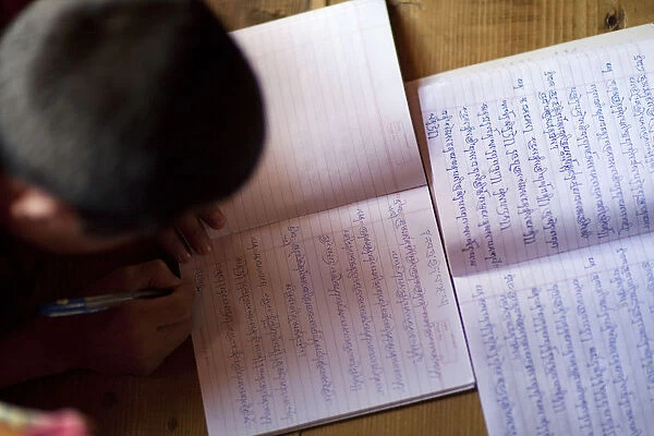 A young monk studying and writing sanskrit at the monastery in Thimpu Bhutan