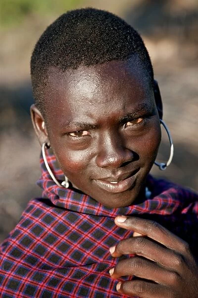 A young Pokot warrior with large round earrings. The Pokot are pastoralists speaking a Southern Nilotic