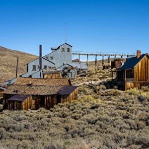 Abandoned wooden structures in Bodie ghost town against clear sky, Mono County
