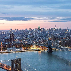 Aerial of Midtown Manhattan with Empire state building and East river at dusk, New York