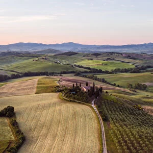 Aerial view of farmhouse and valley at sunrise, Tuscany, Italy