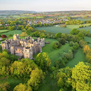 Aerial view of the impressive medieval ruins of Raglan Castle, Monmouthshire, Wales. Spring (May) 2022