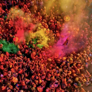 Aerial view of people celebrating the holy colour festival at Shri And Baba Temple, Nandgaon, Uttar Pradesh, India