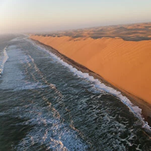 Aerial view over sand dunes & sea, Namib Desert, Namibia