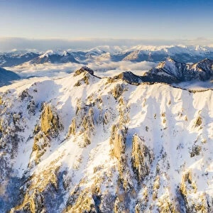 Aerial view of snow capped Torrione del Pertusio and Monti Lariani, Lake Como