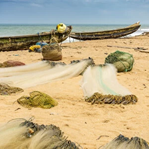 Africa, Benin, Grand Popo, folded fishing nets and boats on the sandy beach