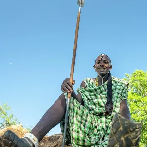 africa, Tanzania, Manyara Region. A maasai warrior sitting and showing his traditional motor bike sandals africa, Tanzania, Manyara Region. A maasai warrior sitting and showing his traditional motor bike sandals
