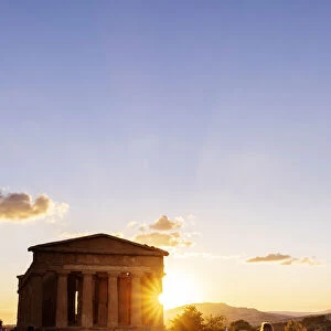 Agrigento, Sicily. People visiting Concordia Temple in the Valley of Temples at sunset