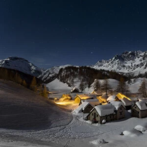The Alp Crampilo (Alpe Crampiolo) covered with snow in a full moon night in winter
