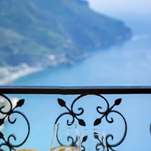 Amalfi Coast, Italy, a table for two, a summer hat and two glasses of white wine with