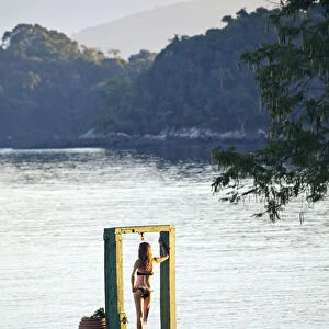 Angra dos Reis; Green Coast (Costa Verde) Ilha Grande, a model stands in an arch