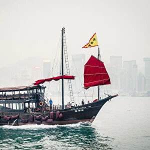 Aqua Luna traditional Junk ship sailing in Victoria Harbor, Tsim Sha Tsui, Kowloon