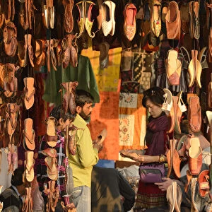 Asian woman buying shoes in market, Jaipur, India, Asia