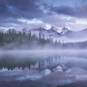 Atmospheric misty sunrise in Banff National Park in the Canadian Rockies, Alberta, Canada