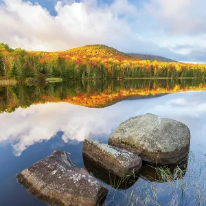 Autumn reflection on Noyes Pond (aka Seyon Pond) in autumn with rocks, Groton, Vermont, USA Autumn reflection on Noyes Pond (aka Seyon Pond) in autumn with rocks, Groton, Vermont, USA