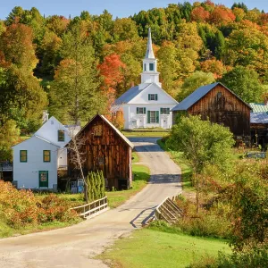 Autumn over road with white-steeple church and red barn, Green Mountains, Waits River, Vermont, USA Autumn over road with white-steeple church and red barn, Green Mountains, Waits River, Vermont, USA