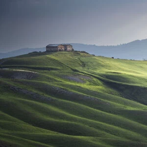 A barn and the rolling hills, Crete Senesi, Tuscany, Italy