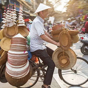 Basket & hat seller on bicycle, Hanoi, Vietnam